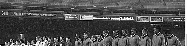 Players for the Mexican and Jamaican women's teams present themselves before a nearly empty house at RFK Stadium in Washington, D.C., prior to the CONCACAF group stagte fimale on 21 October 2014.  Final score: Mexico 3-1 Jamaica.  The Mexican team advances to face the U.S. Women's National Team in the 2014 CWC semifinals.