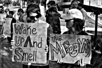 Protesters gather outside Waking Life Espresso in Asheville, North Carolina, in September 2015, denouncing misogyny and the sexually harassing, predatory assertion of the pickup artist after the coffee shop's owners, Jared Rutledge and Jacob Owens, were revealed by a local blogger as PUAs who advocate and blog their ideas and behavior.  (Uncredited photo via Salon.com)